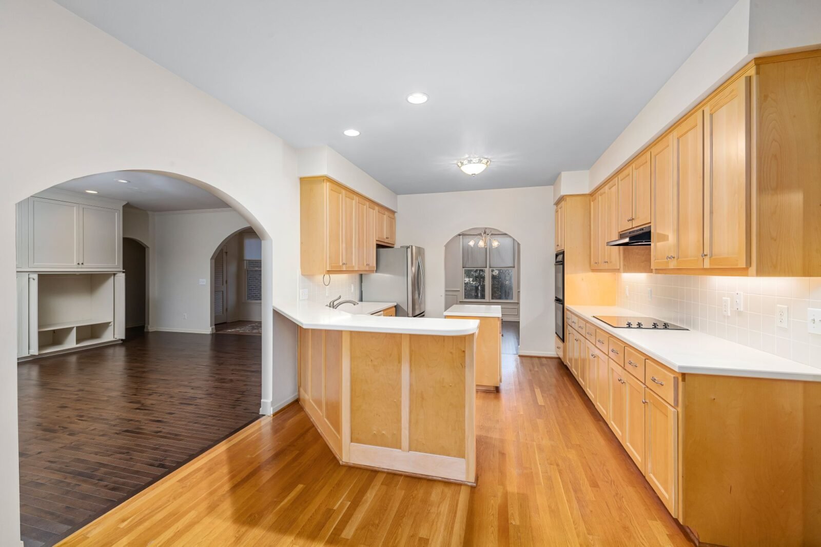 Kitchen with timber cabinetry and white benchtops